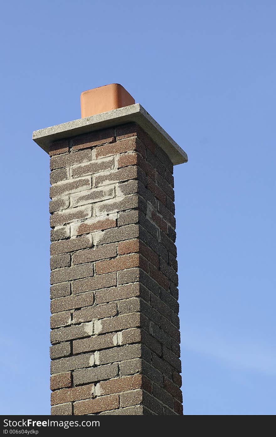 Multi Brown Brick Chimney Against a Blue Sky Background