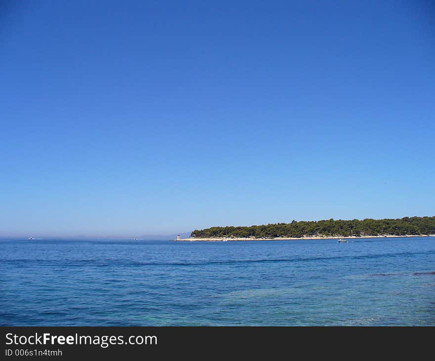 Blue sea with view of an island in the distance. Blue sea with view of an island in the distance