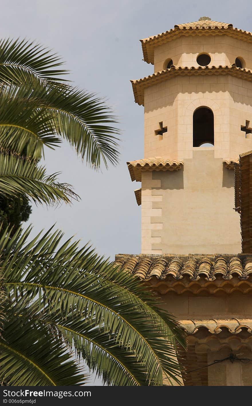 Church tower with palm tree to left