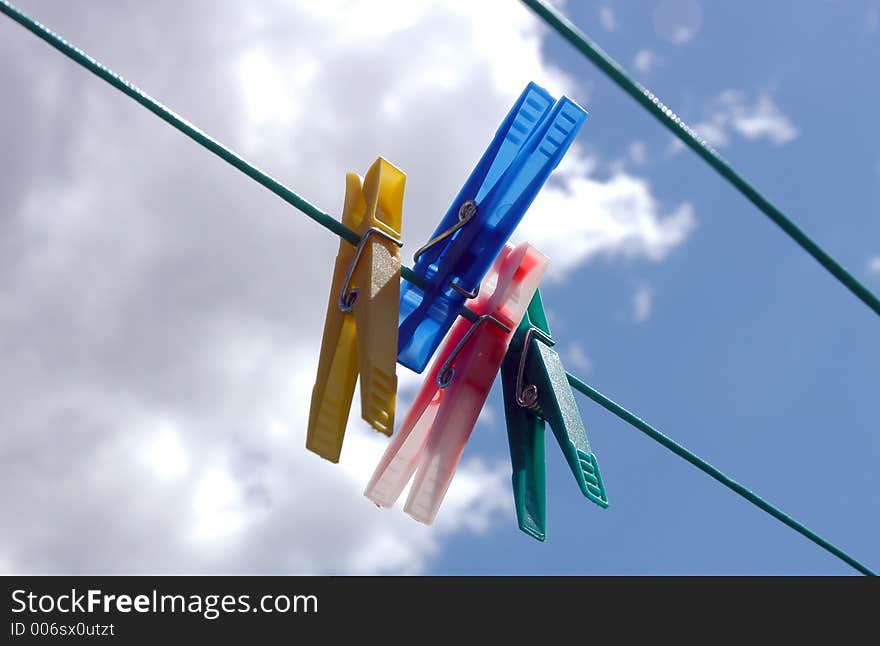 Pegs hanging on clothes line. Pegs hanging on clothes line