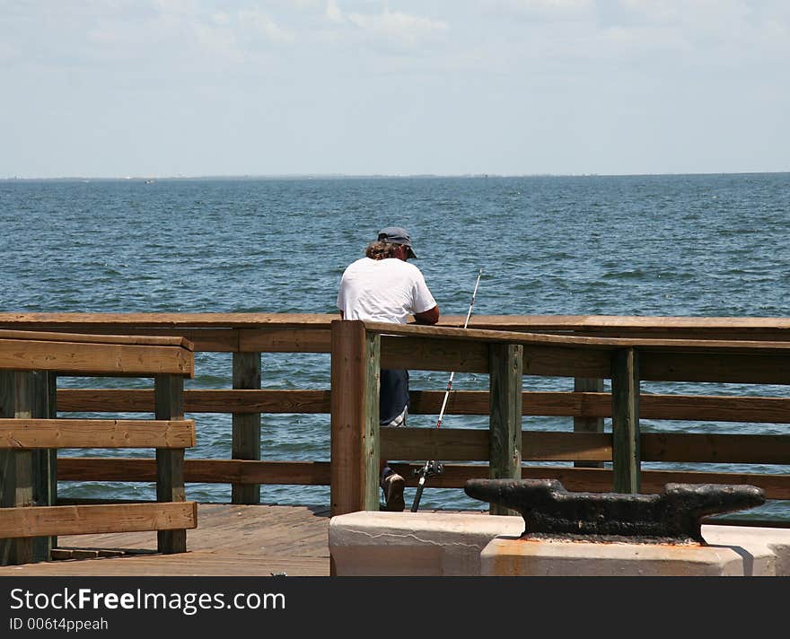 Lonely fisherman waiting for a catch. Lonely fisherman waiting for a catch.