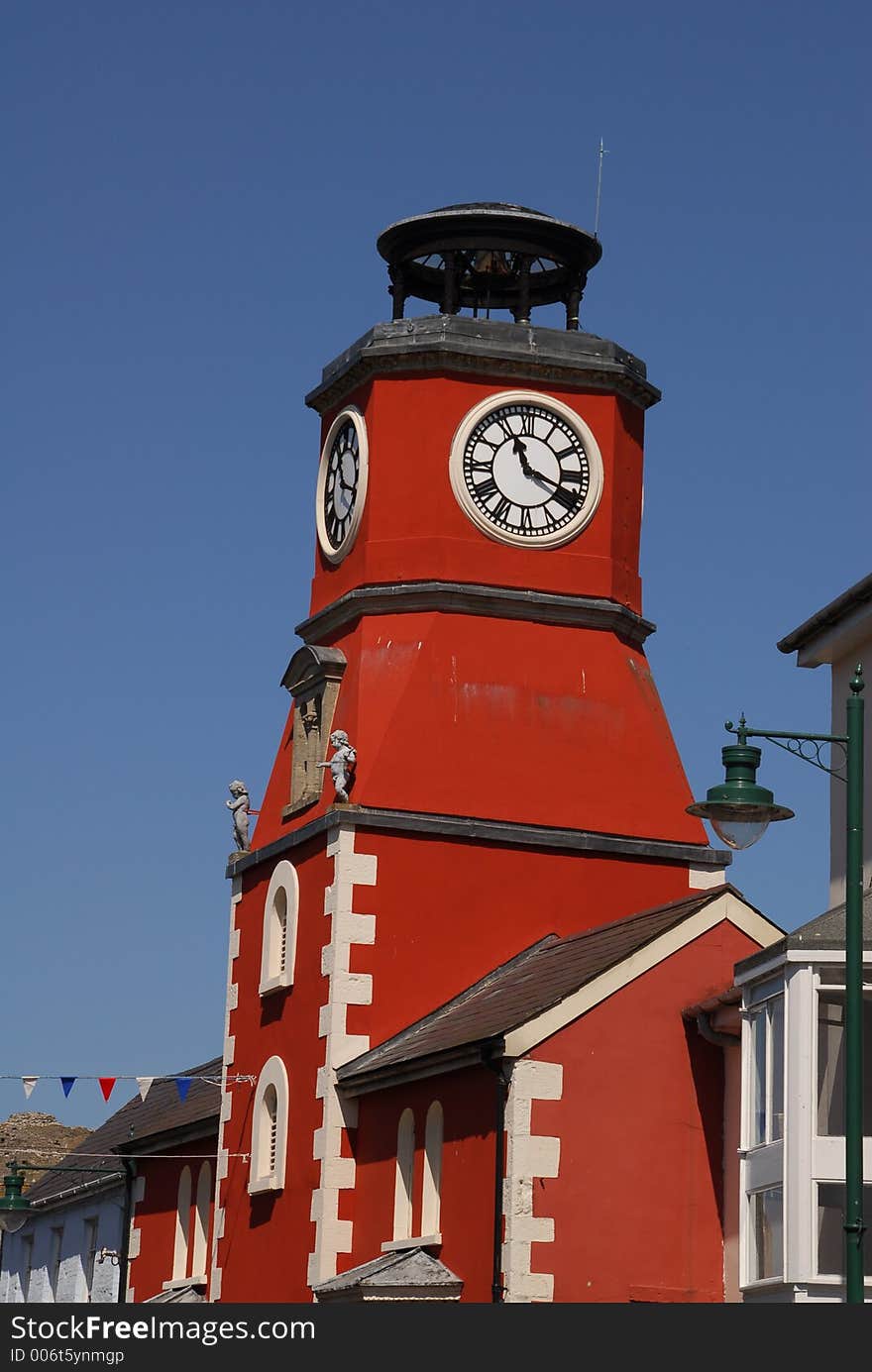 The dark red building houses a big clock that can be seen from all directions. The dark red building houses a big clock that can be seen from all directions.