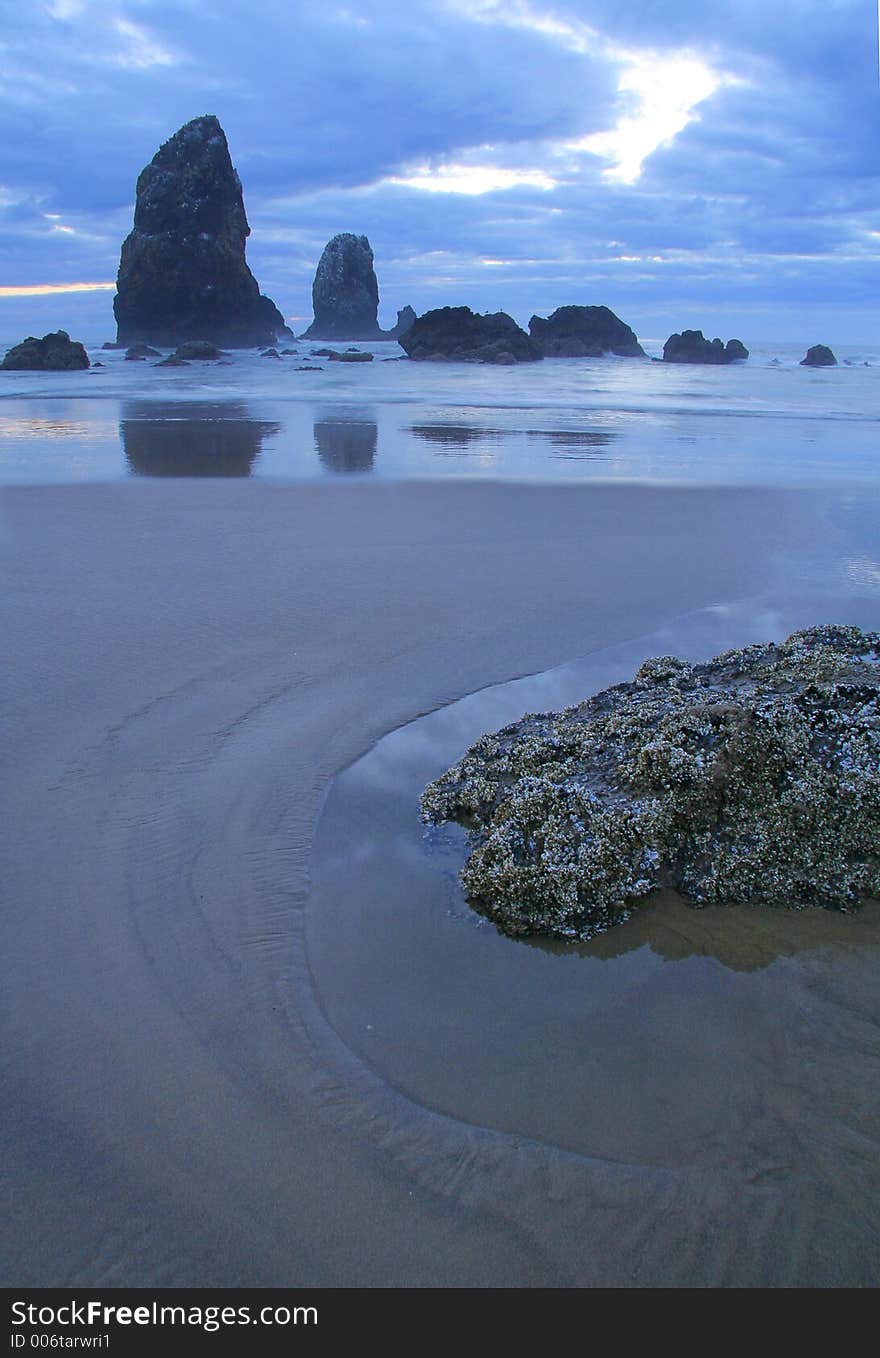 Evening at the Pacific Coast - sand, rocks, reflections