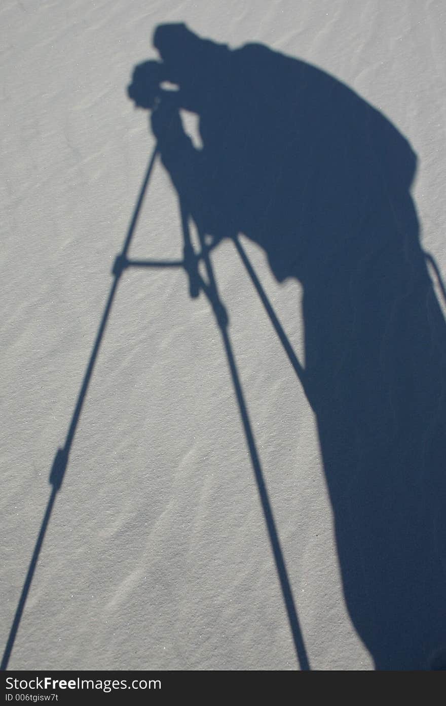 Shadow of a photograph on waves of white sand created by the wind. Shadow of a photograph on waves of white sand created by the wind