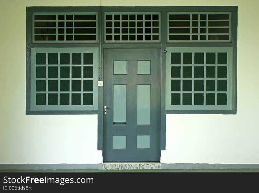 An old Chinese house with green door and windows. An old Chinese house with green door and windows