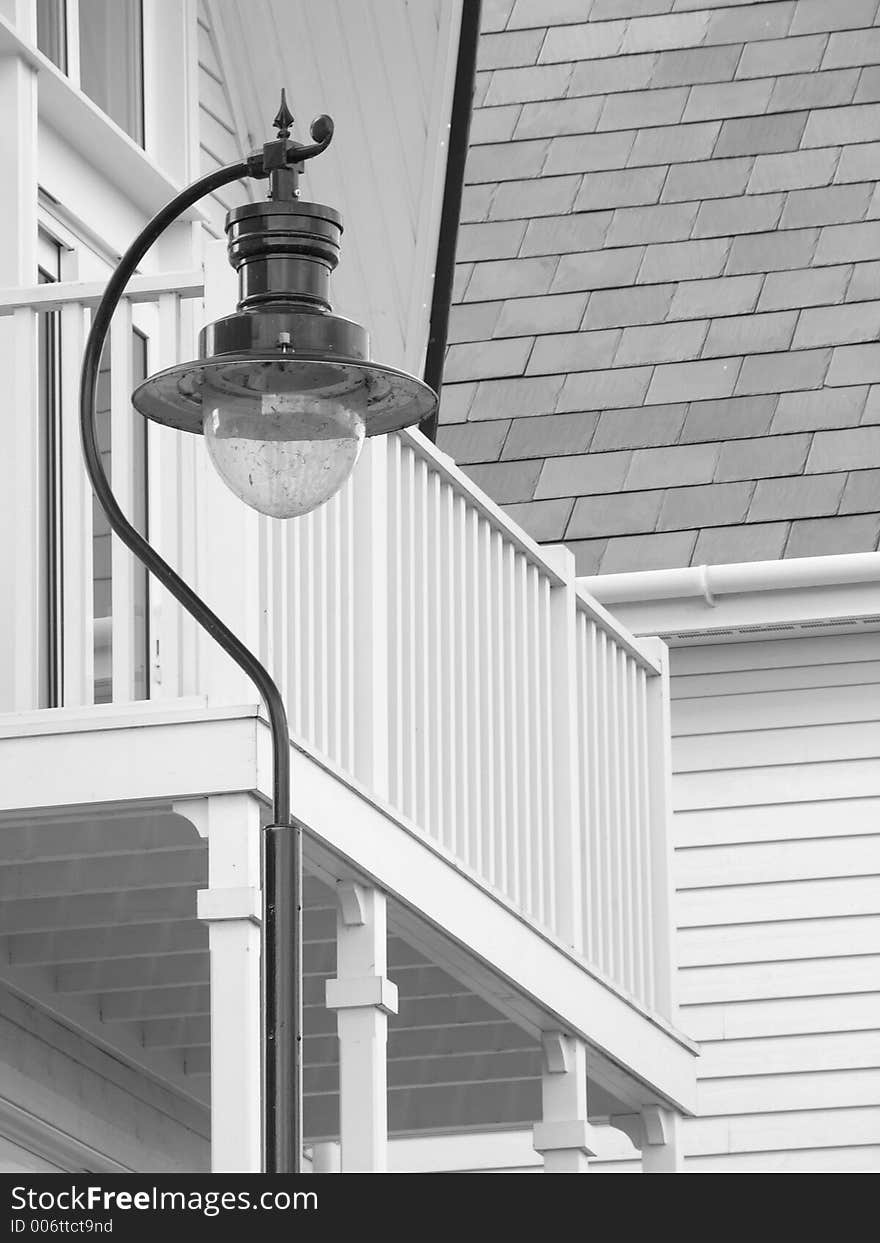 Rustic lampost outside wooden house. Rustic lampost outside wooden house