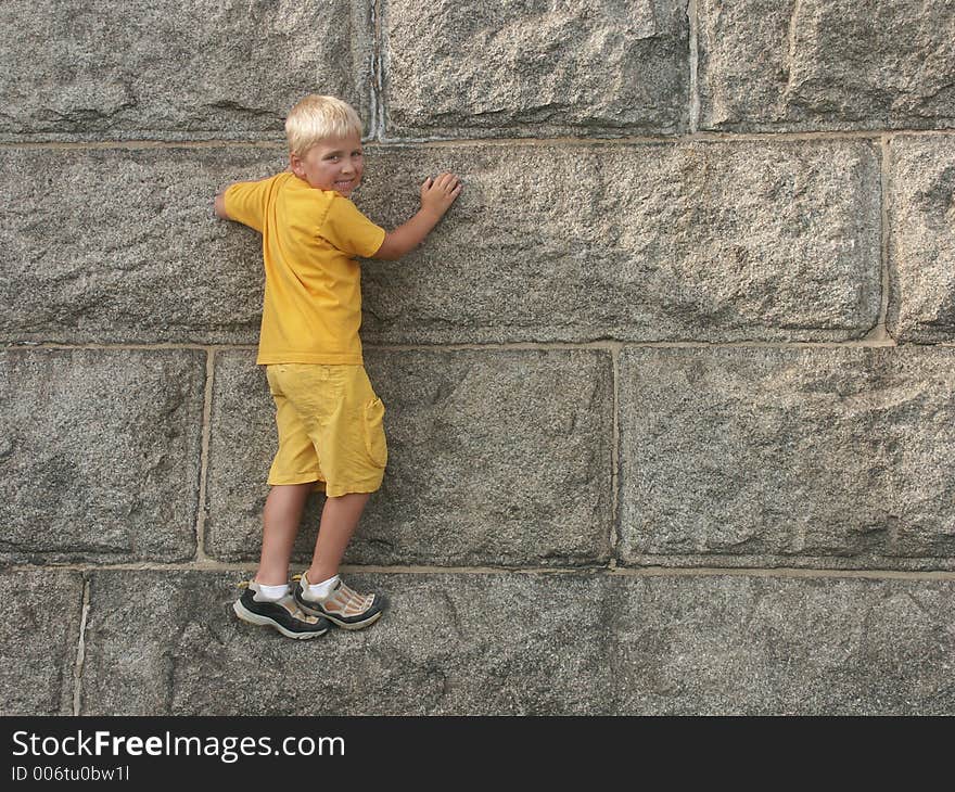 Little boy is climbing the base of Statue Of Liberty. Little boy is climbing the base of Statue Of Liberty