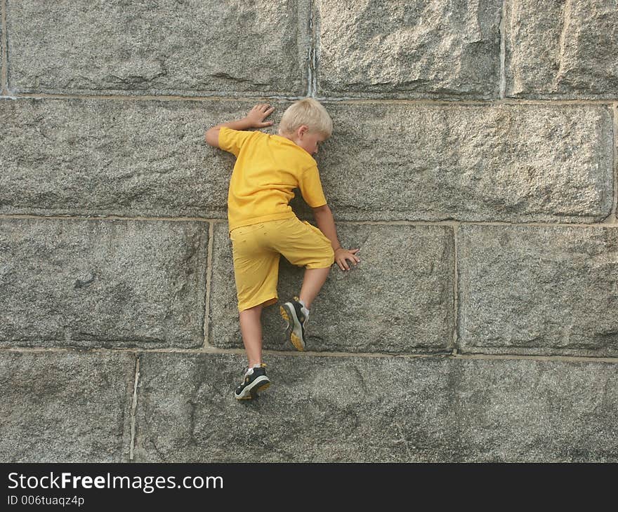 A little boy is climbing the base of Statue Of Liberty. A little boy is climbing the base of Statue Of Liberty