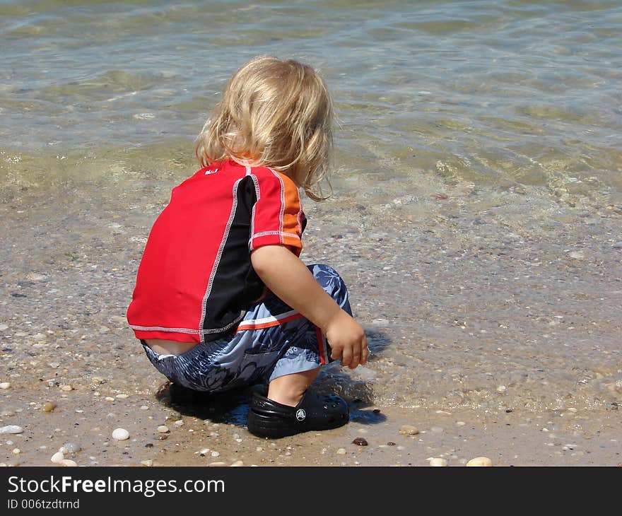 Child Playing In Ocean