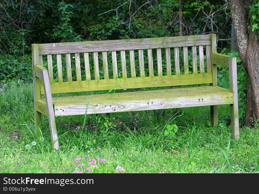 An old weathered bench in the yard. An old weathered bench in the yard