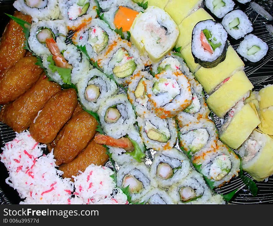 A platter of various kinds of sushi...shrimp tempura, california rolls, salmon rolls, cucumber rolls, and the house special. A platter of various kinds of sushi...shrimp tempura, california rolls, salmon rolls, cucumber rolls, and the house special