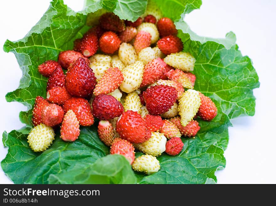 Many strawberries on the leaf