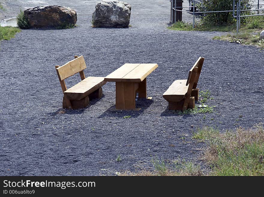 Picnic area with bench and table at parking lot