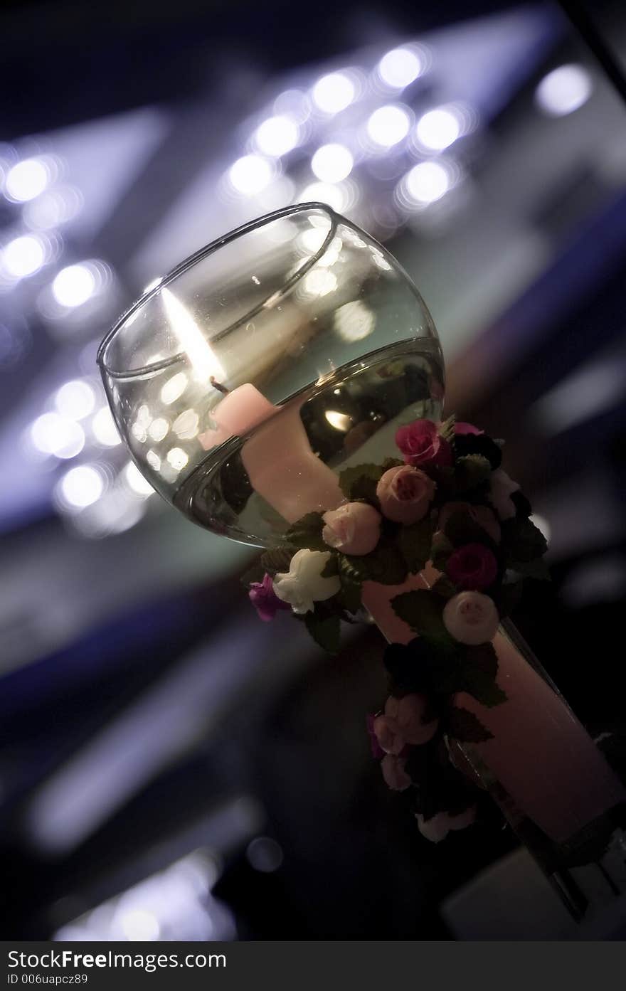 Candle Lit while floating in a glass vase with a beautiful back ground. Candle Lit while floating in a glass vase with a beautiful back ground.