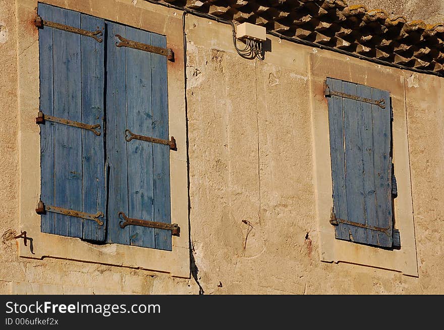 Two blue wood shutters closed. Two blue wood shutters closed