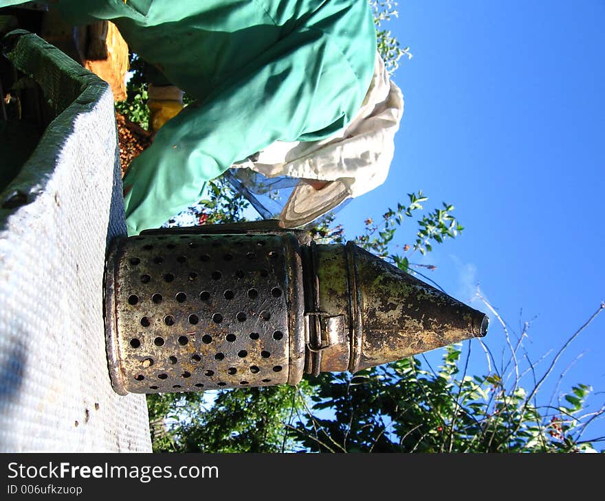 A beekeeper at work on his hive. A beekeeper at work on his hive