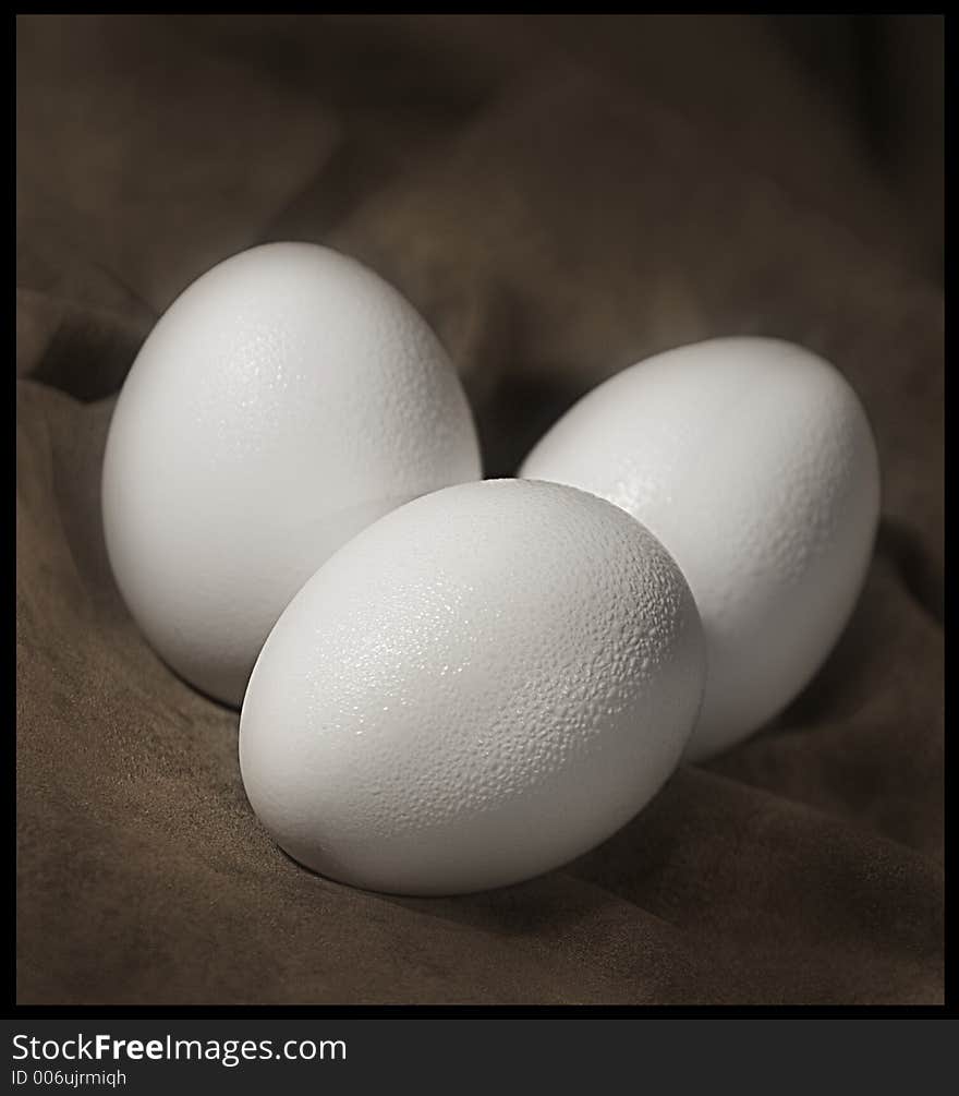 Three eggs on background.