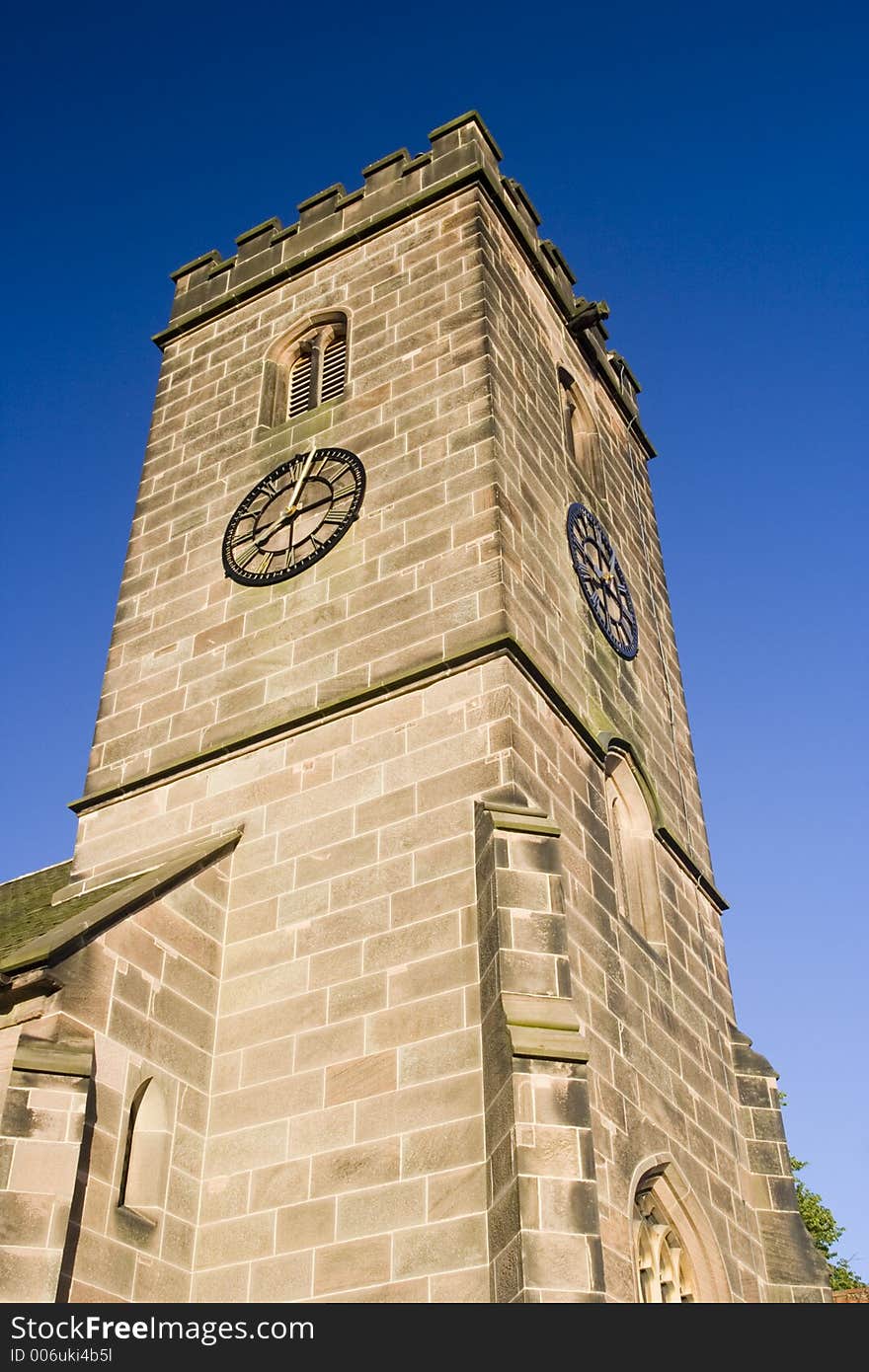 Traditional English stone church tower on summer evening. Traditional English stone church tower on summer evening.