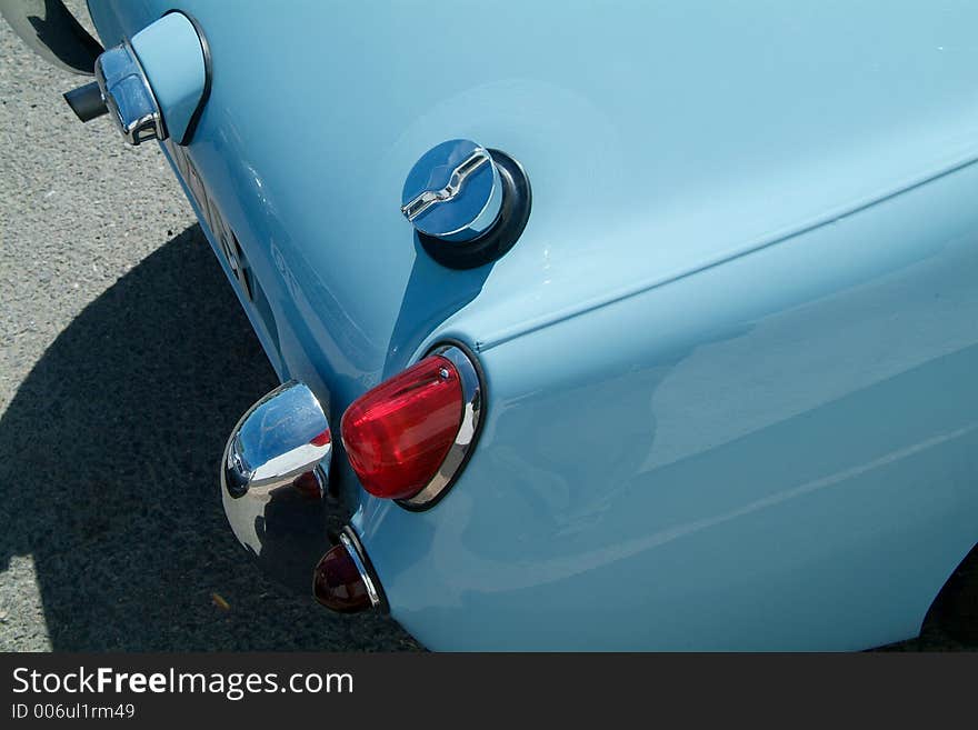 Detail of classic, light blue English sportscar. Detail of classic, light blue English sportscar