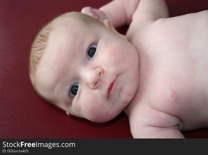 A close up of a chubby baby on a doctors table. A close up of a chubby baby on a doctors table.