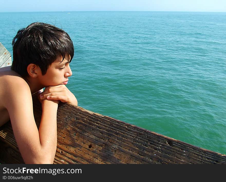 Boy looking out over the ocean. Boy looking out over the ocean