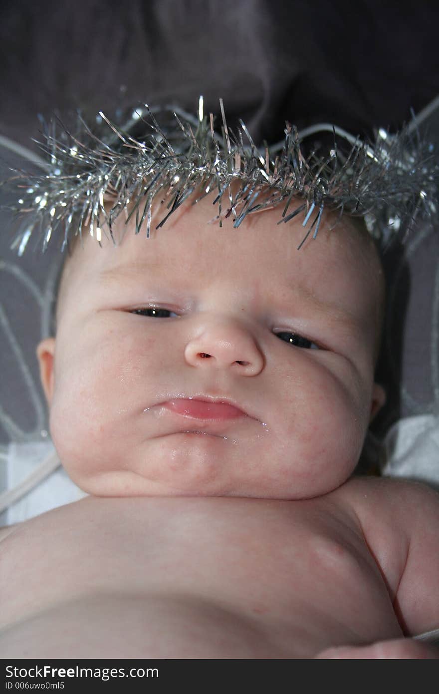 A close up of a chubby baby with a halo. A close up of a chubby baby with a halo.