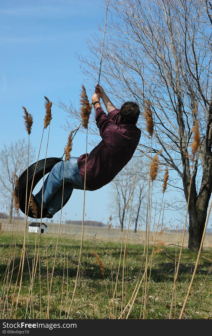 Active man on swing tire