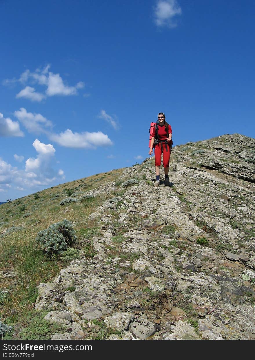 Women for red going along mountain. Women for red going along mountain