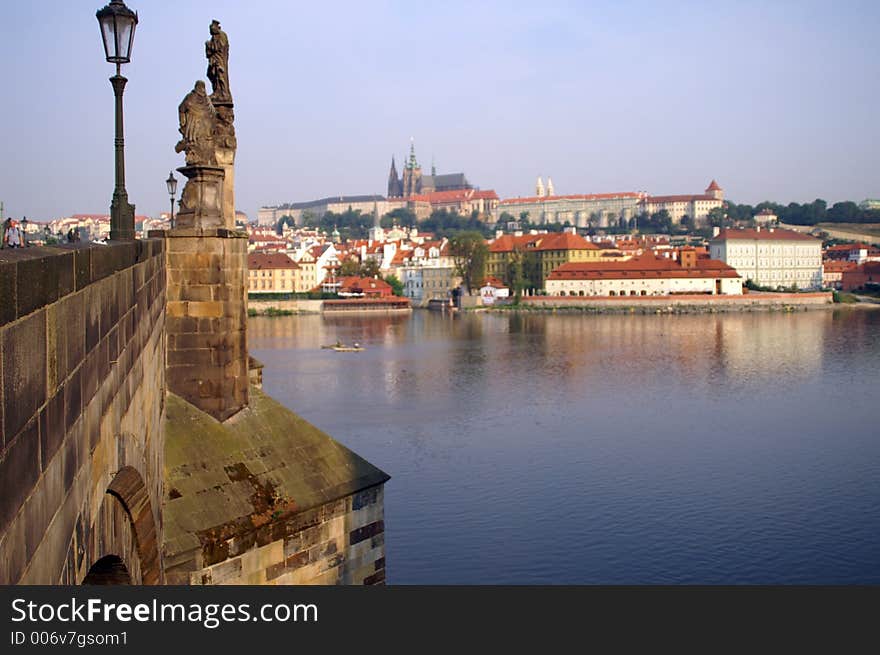 Statues of Charles bridge  and barocco churches - beautiful scene in old prague city. Statues of Charles bridge  and barocco churches - beautiful scene in old prague city