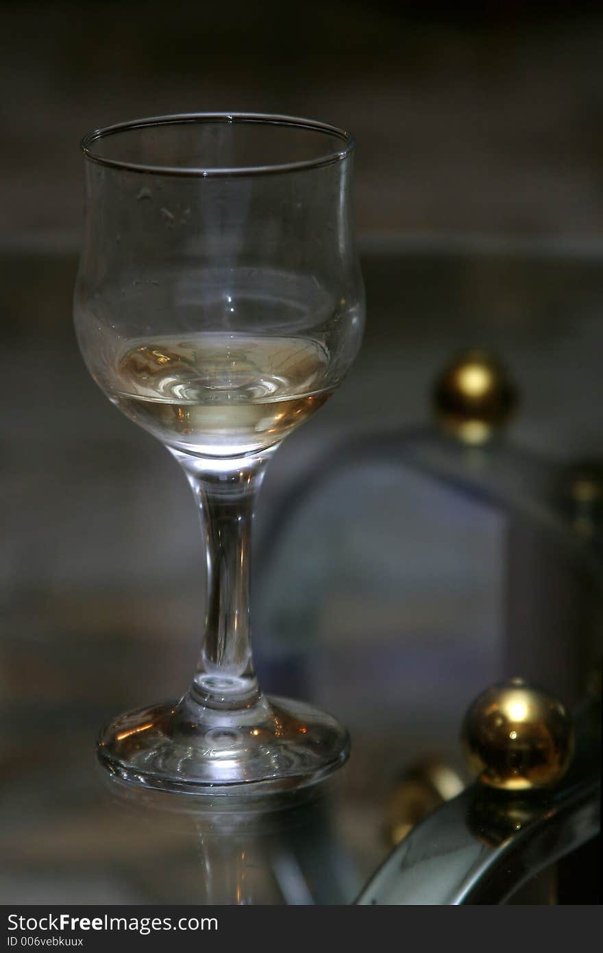 Wine glass with a wine on a transparent table. Wine glass with a wine on a transparent table