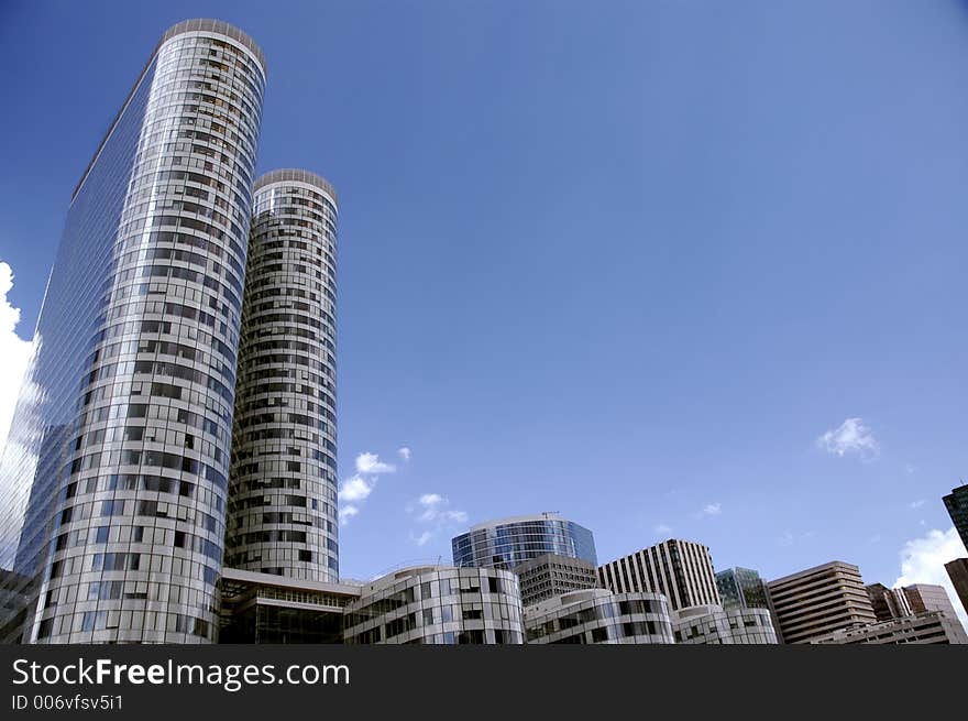 Panorama of few round skyscrapers over blue sky. Panorama of few round skyscrapers over blue sky