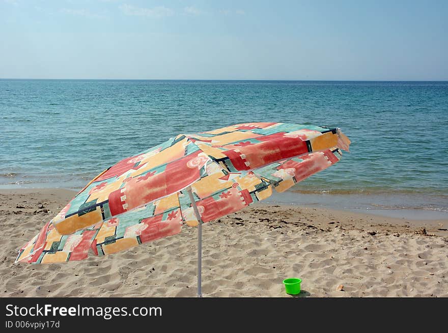 Sea beach with umbrella in front