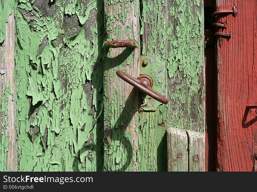 Green door and a rusty key. Green door and a rusty key