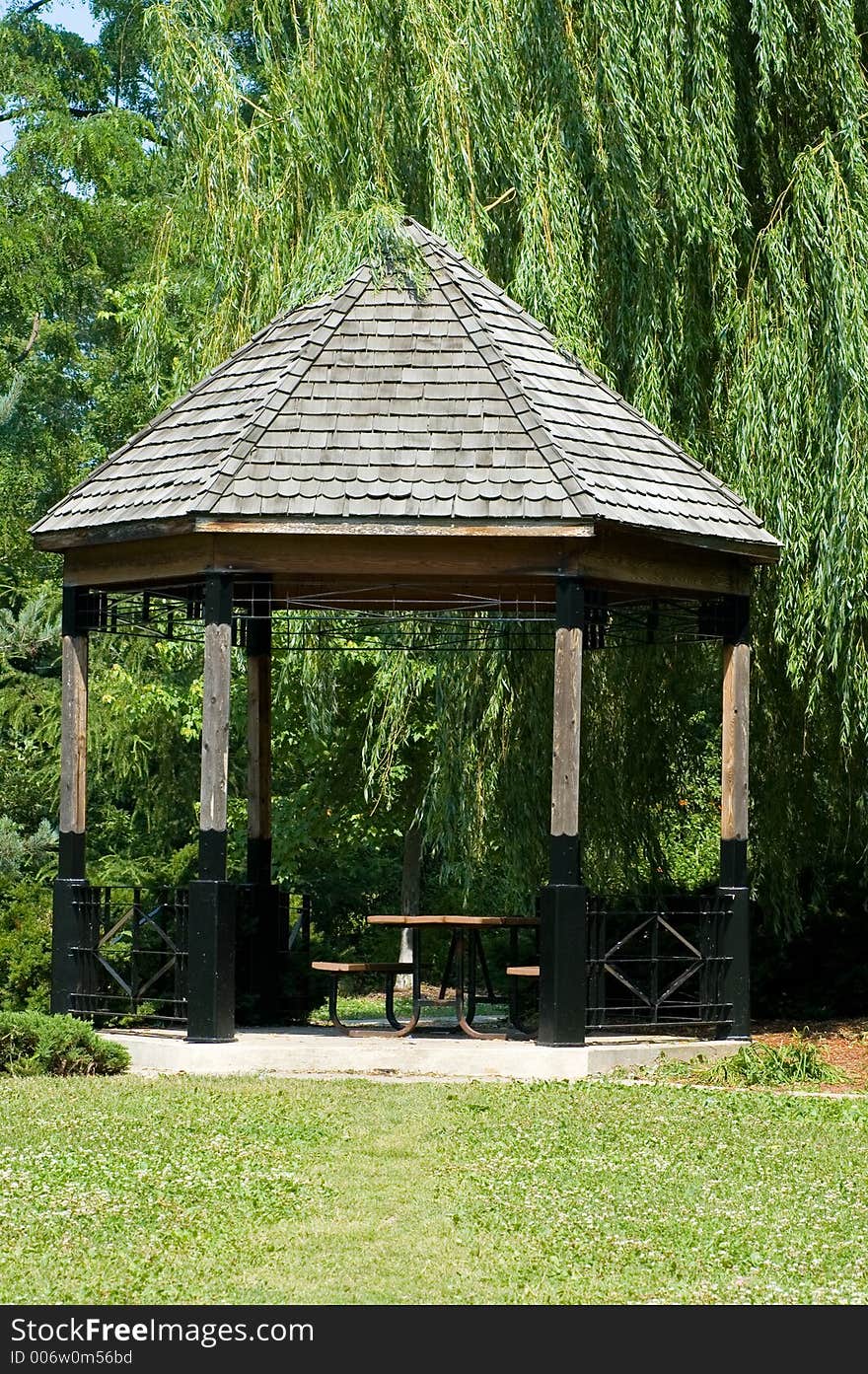 Peaceful looking wooden gazebo, in a local park.