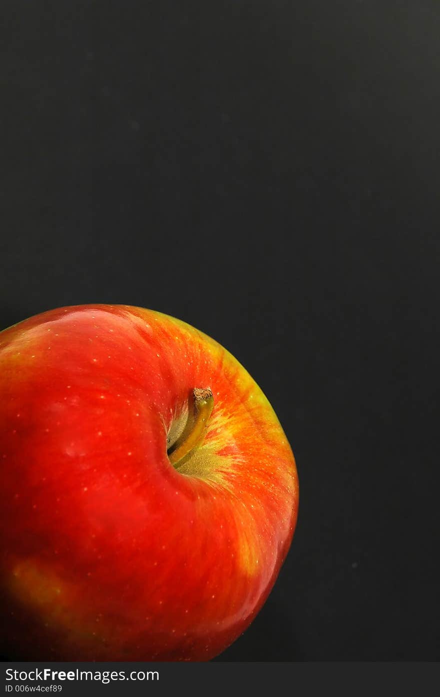 Red apple on black background close up. Red apple on black background close up