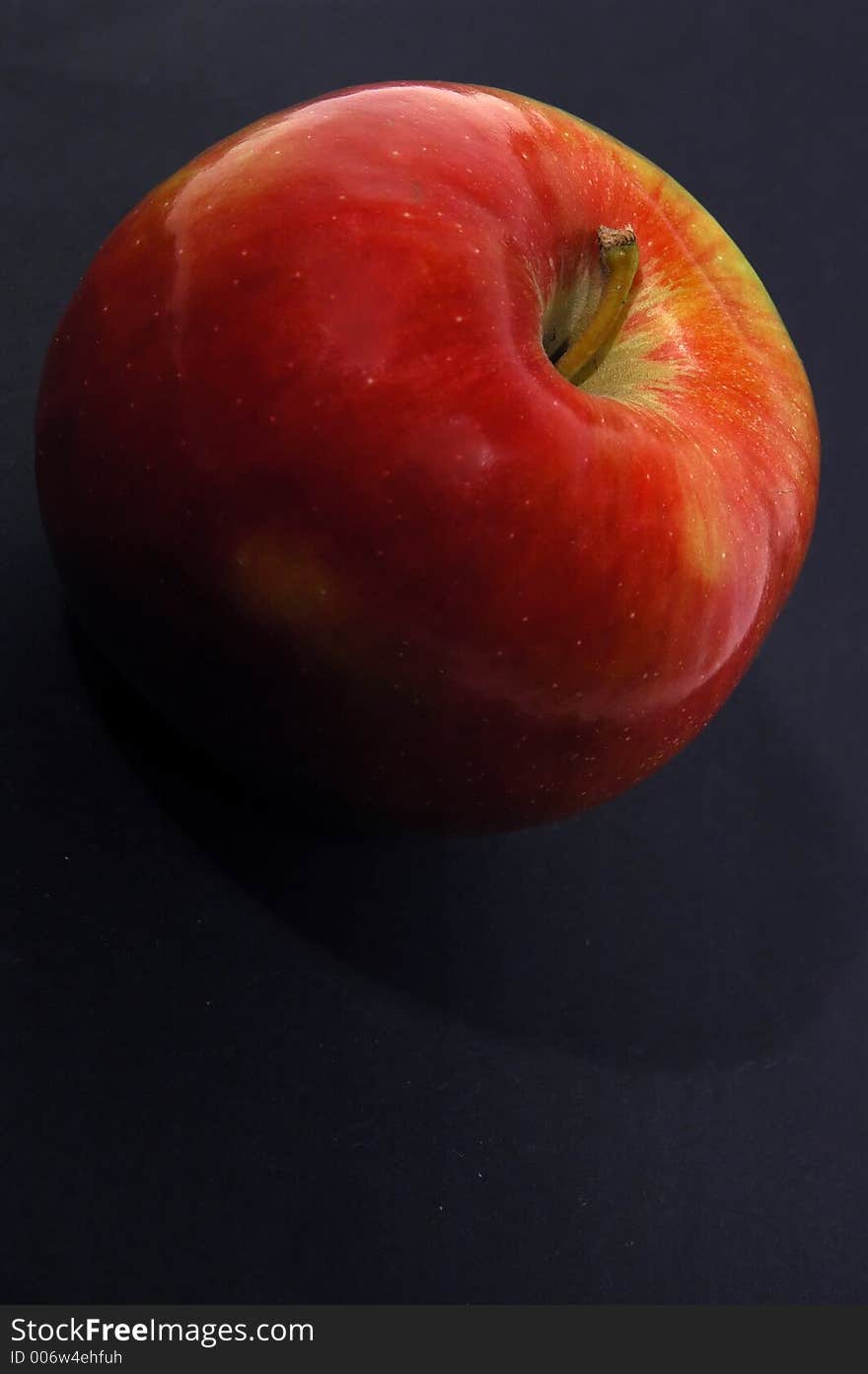 Red apple on black background close up. Red apple on black background close up