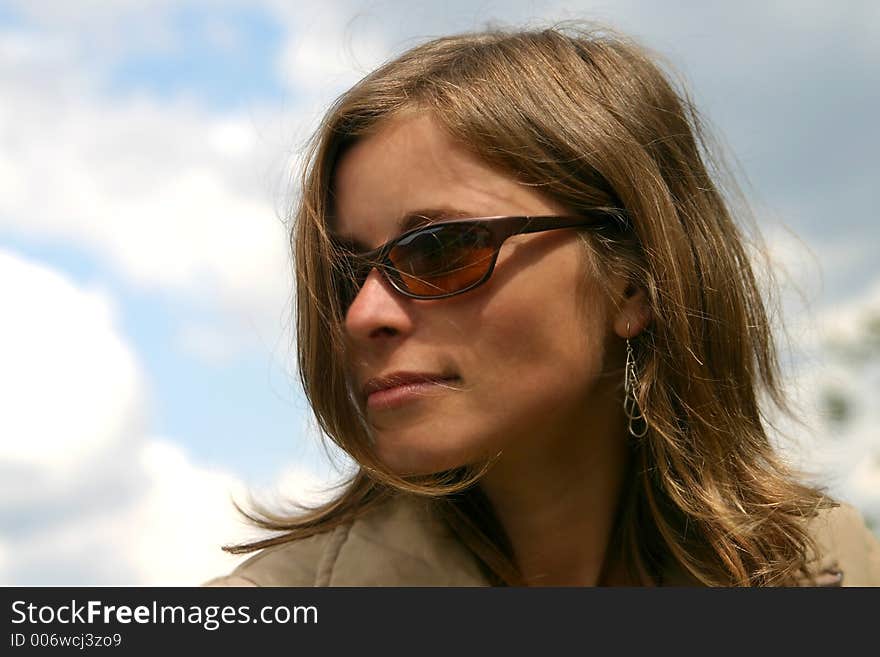 Girl with sunglasess portrait on summer sky background. Girl with sunglasess portrait on summer sky background