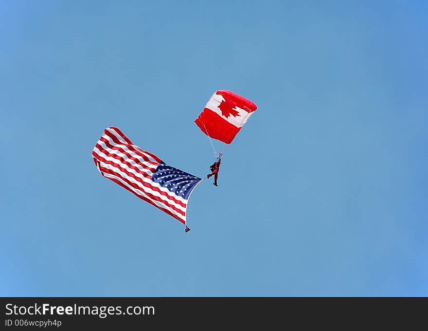 canadian parachutist carrying US national flag. canadian parachutist carrying US national flag