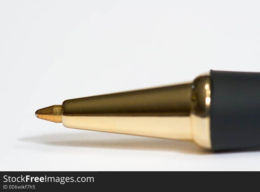 Macro of the tip of a writing pen shot on white paper. Macro of the tip of a writing pen shot on white paper.