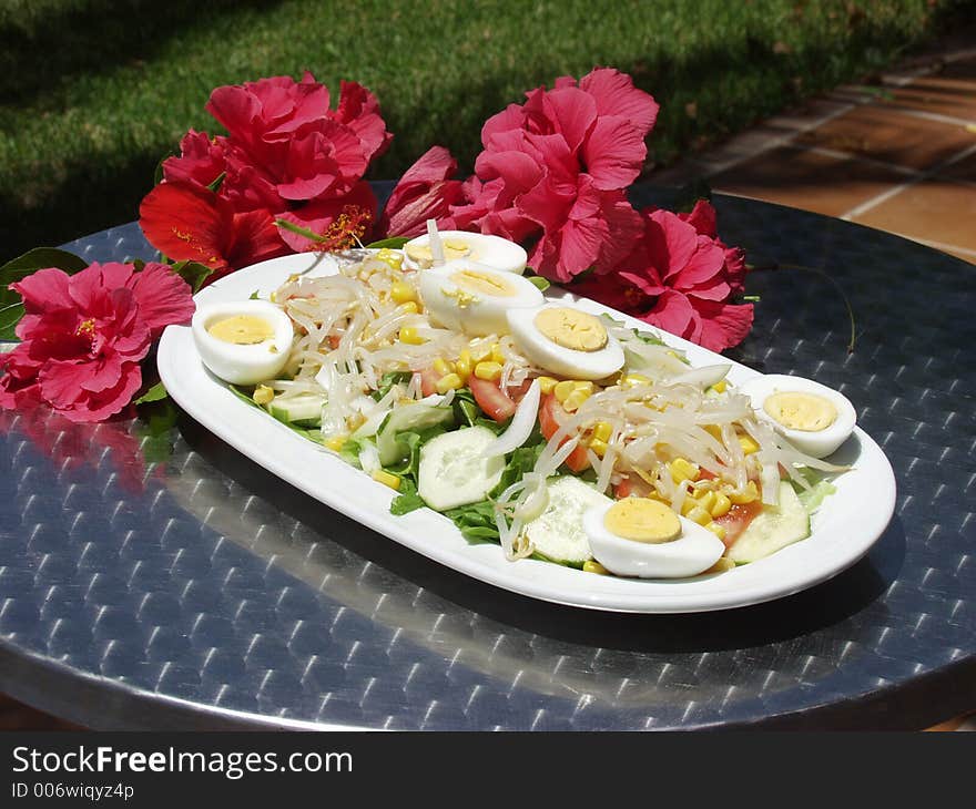 Fresh salad on a table whit flowers. Fresh salad on a table whit flowers