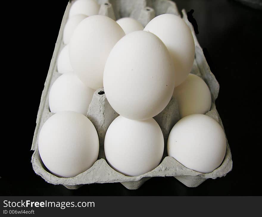 Extra large white egges piled in a carton. Extra large white egges piled in a carton