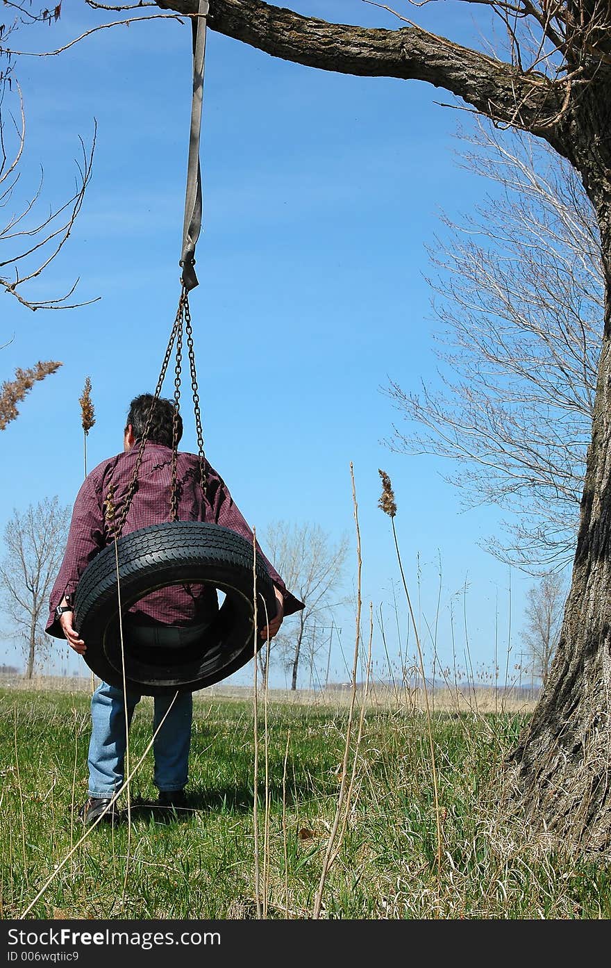 Active man on swing tire. Active man on swing tire