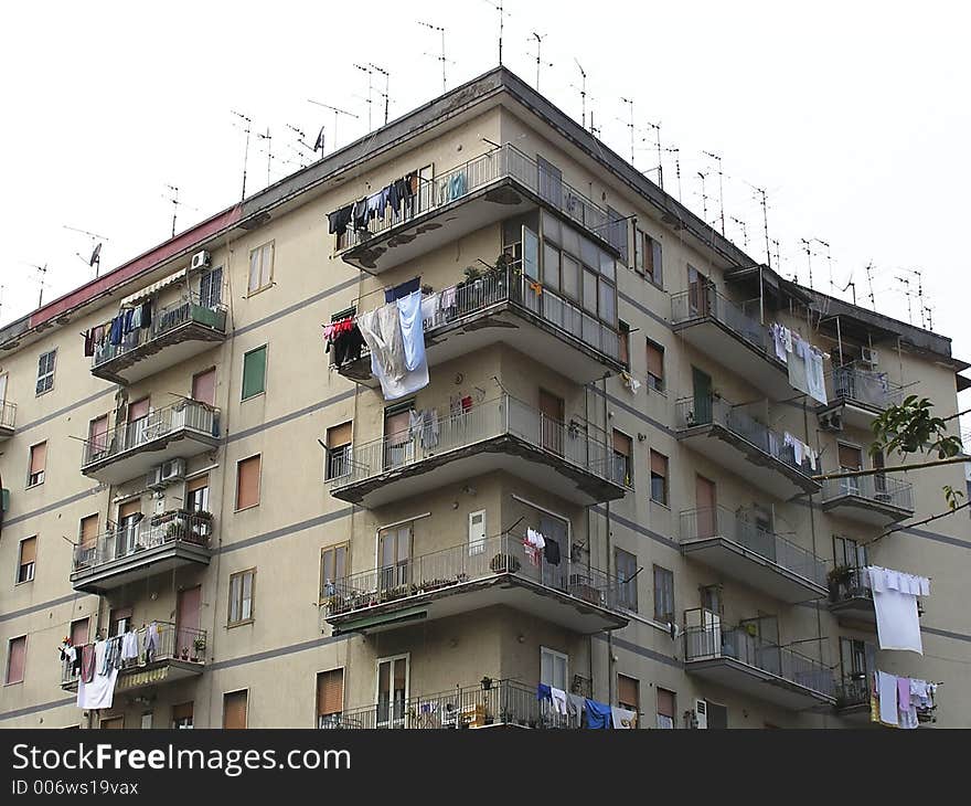 Typical  Europeans streetscapes in the Mediterranean coast with apartments houses, antennas on the roofs  and clotheslines on the balconies, Herculaneum City,  Italy. Typical  Europeans streetscapes in the Mediterranean coast with apartments houses, antennas on the roofs  and clotheslines on the balconies, Herculaneum City,  Italy