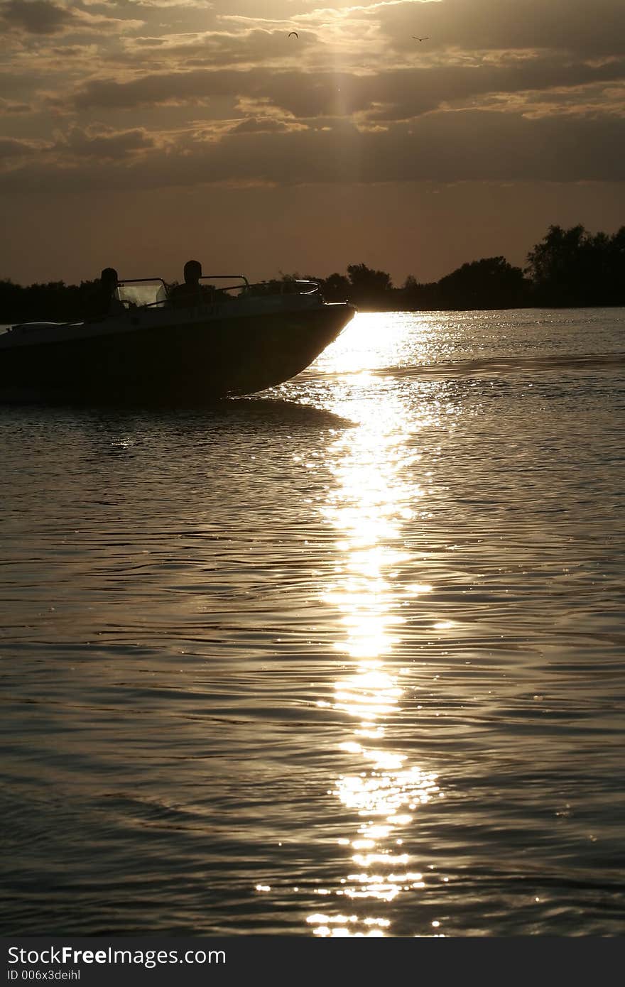 Sunset reflection on the Danube River and boat silhouette