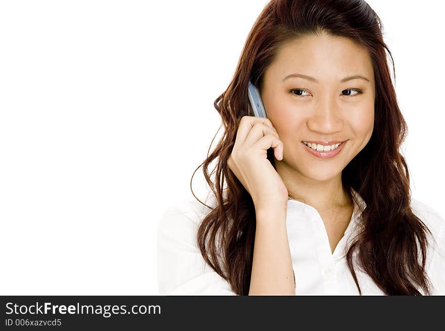 A beautiful asian woman holding a mobile cell phone. A beautiful asian woman holding a mobile cell phone