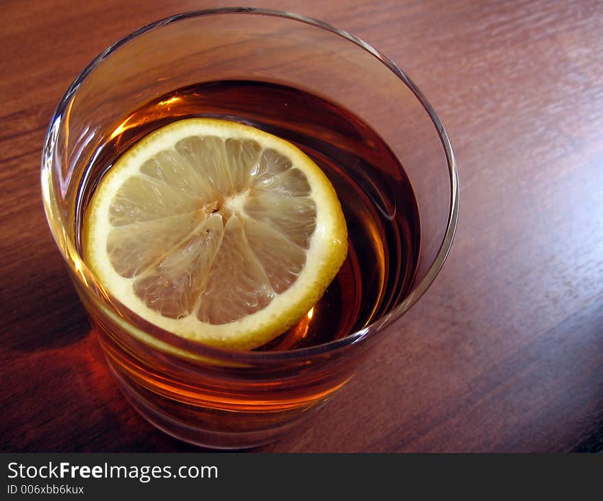 Black tea with lemon in the glass. Black tea with lemon in the glass