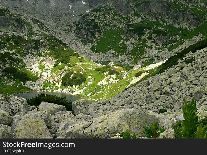 Lost glacial lakes with small water fall in Retezat Mountains - Romania. Lost glacial lakes with small water fall in Retezat Mountains - Romania