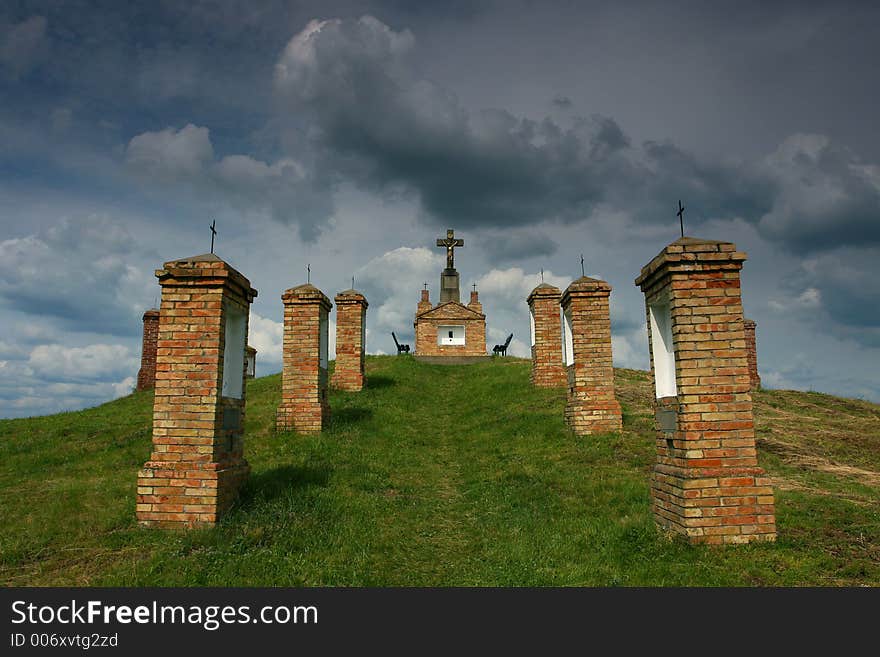 Road to a Christian cross, on a mound. Road to a Christian cross, on a mound