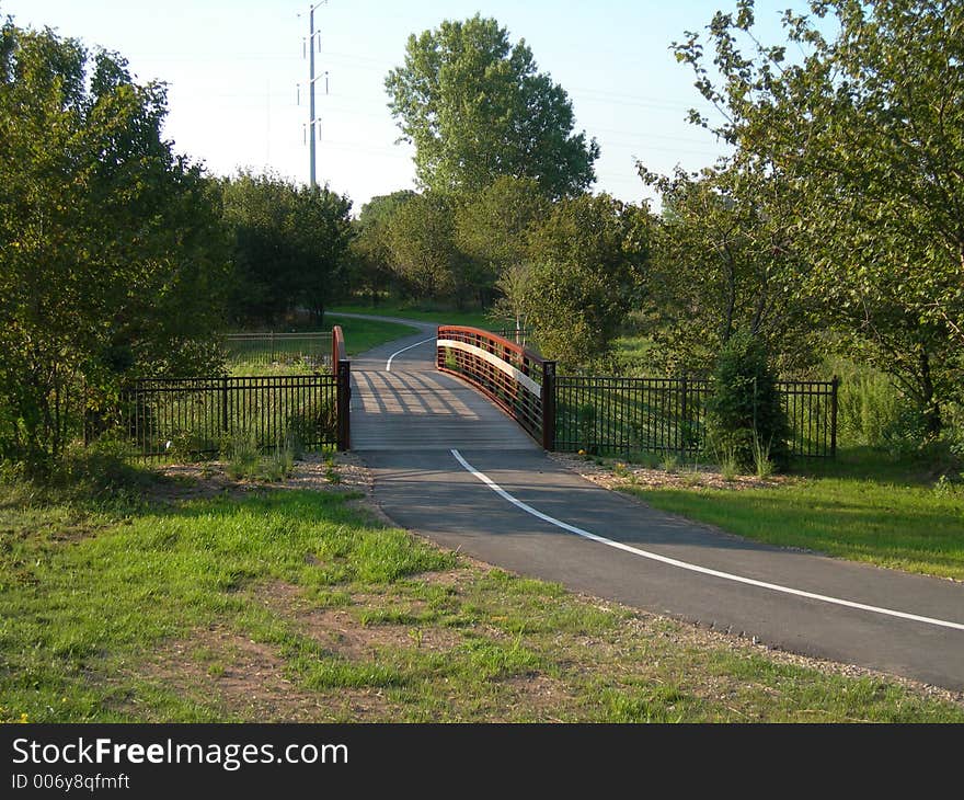 One of several foot bridges in our neighborhood park leads to winding trails. One of several foot bridges in our neighborhood park leads to winding trails.