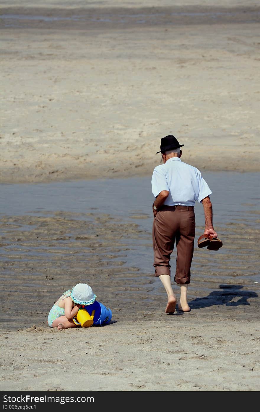 Girl and old man in the beach